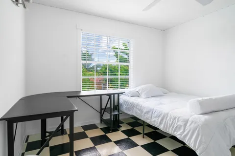 a bedroom with a bed and a window