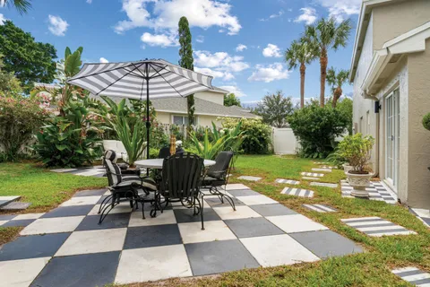 a view of a patio with a table and chairs