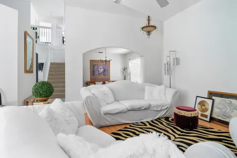 a living room with furniture and a chandelier