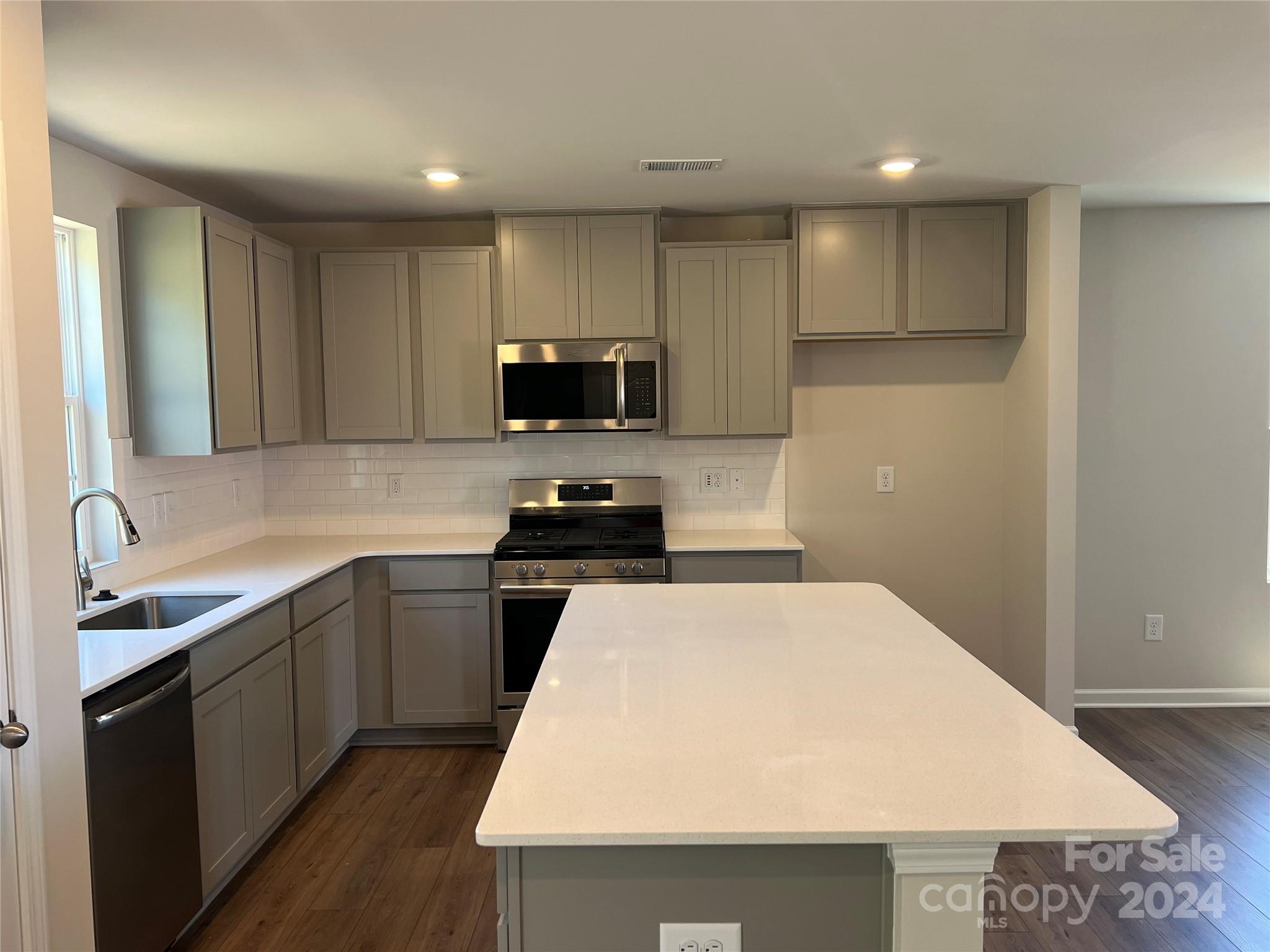 614 Mile Crk Road, Unit 30 Edgemoor, SC 29712 - Photo 3 of 31 a kitchen with a sink a stove top oven and white cabinets