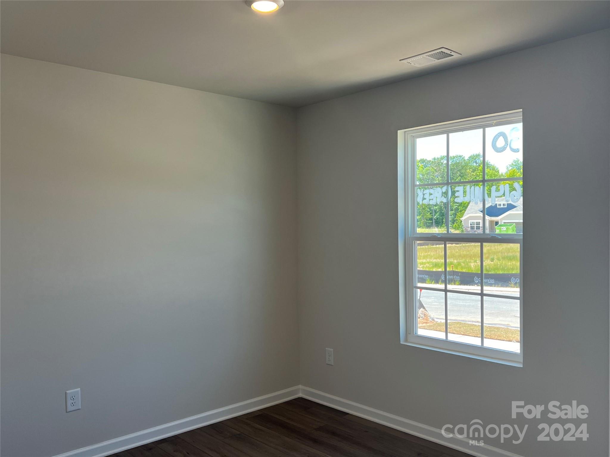 614 Mile Crk Road, Unit 30 Edgemoor, SC 29712 - Photo 5 of 31 an empty room with wooden floor and windows