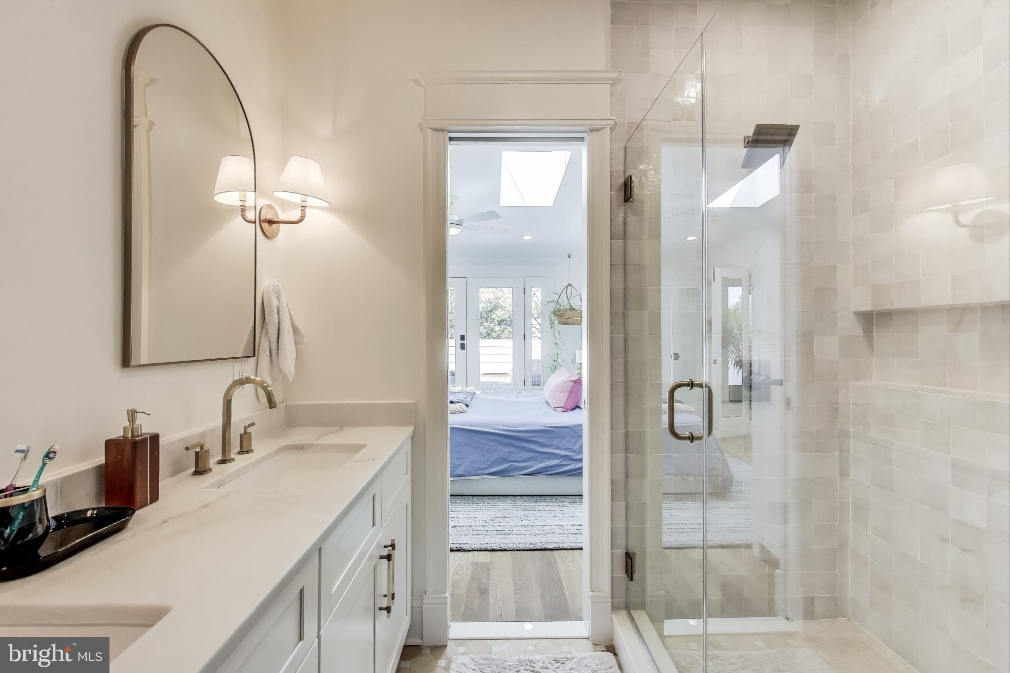1112 E Street Northeast Washington, DC 20002 - Photo 15 of 29 a bathroom with a double vanity sink mirror and shower