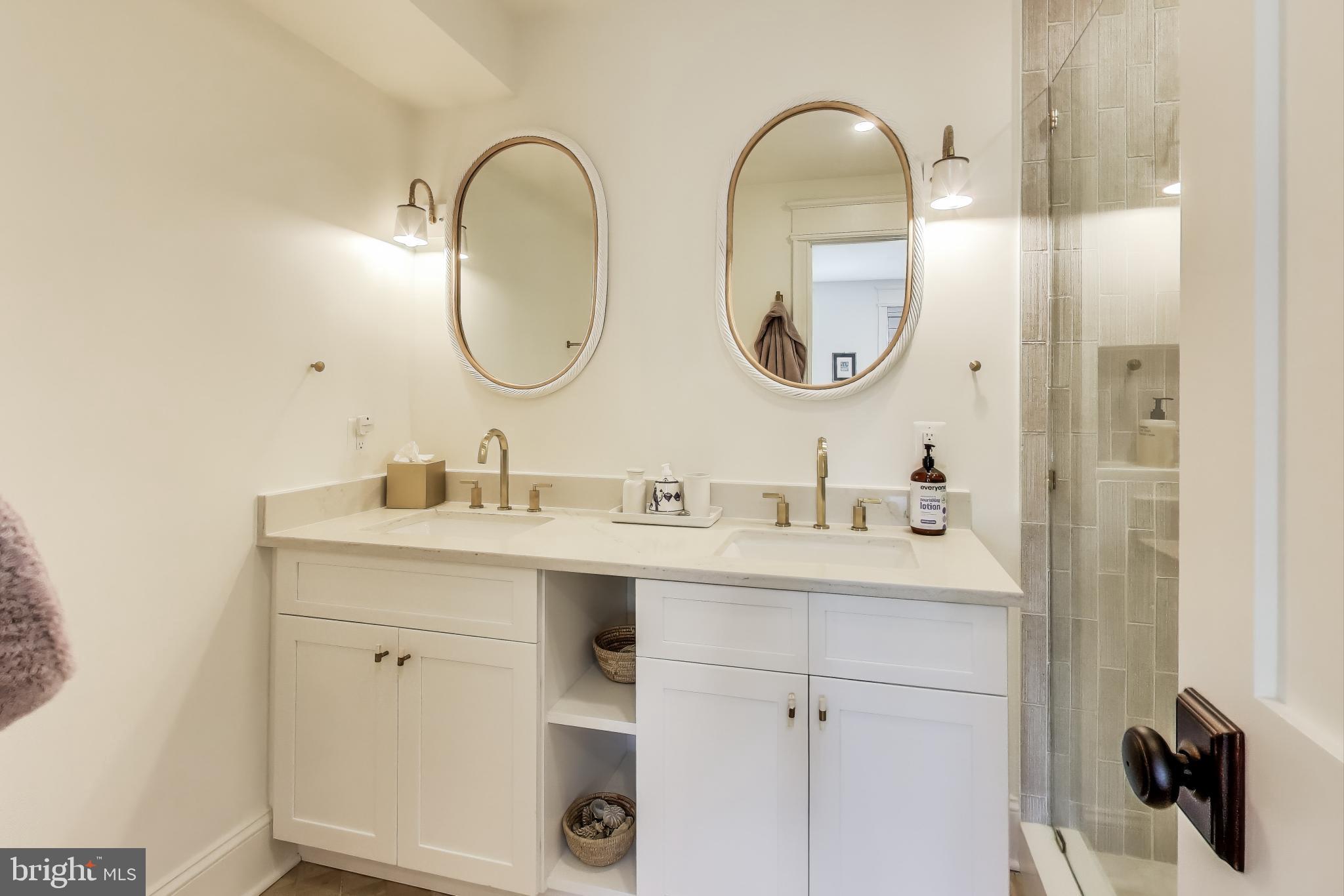 1112 E Street Northeast Washington, DC 20002 - Photo 10 of 29 a bathroom with a double vanity sink and a mirror
