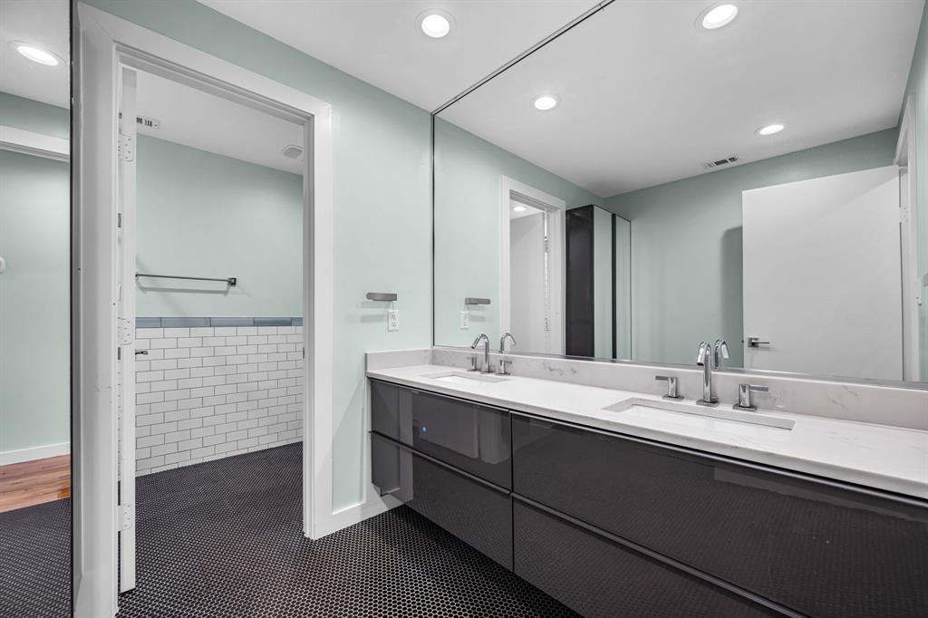 2547 Wentworth Street Dallas, TX 75211 - Photo 15 of 22 a bathroom with a double vanity sink and a mirror
