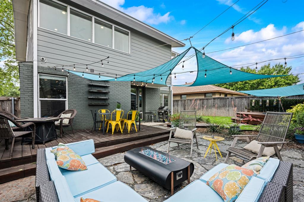 2547 Wentworth Street Dallas, TX 75211 - Photo 18 of 22 a view of a patio with a dining table and chairs with wooden floor