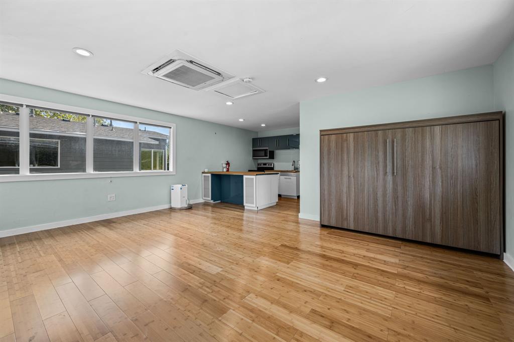 2547 Wentworth Street Dallas, TX 75211 - Photo 19 of 22 an empty room with wooden floor and windows