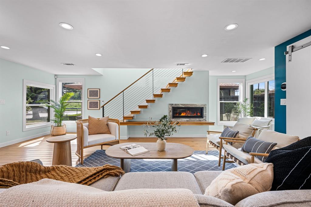 2547 Wentworth Street Dallas, TX 75211 - Photo 2 of 22 a living room with furniture fireplace and a large window