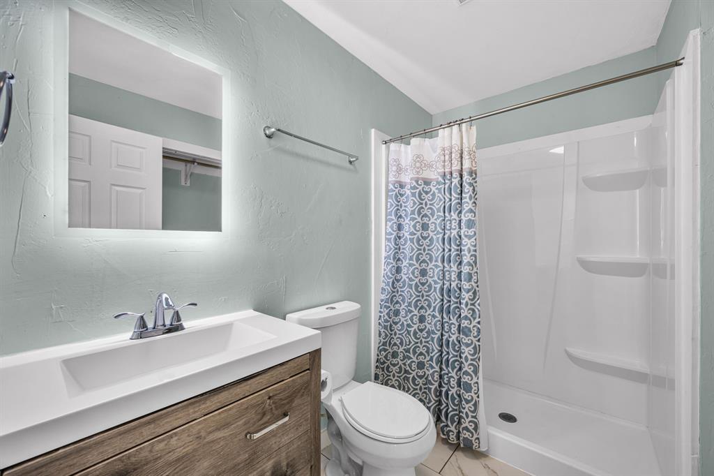 2547 Wentworth Street Dallas, TX 75211 - Photo 21 of 22 a bathroom with a sink a toilet and shower