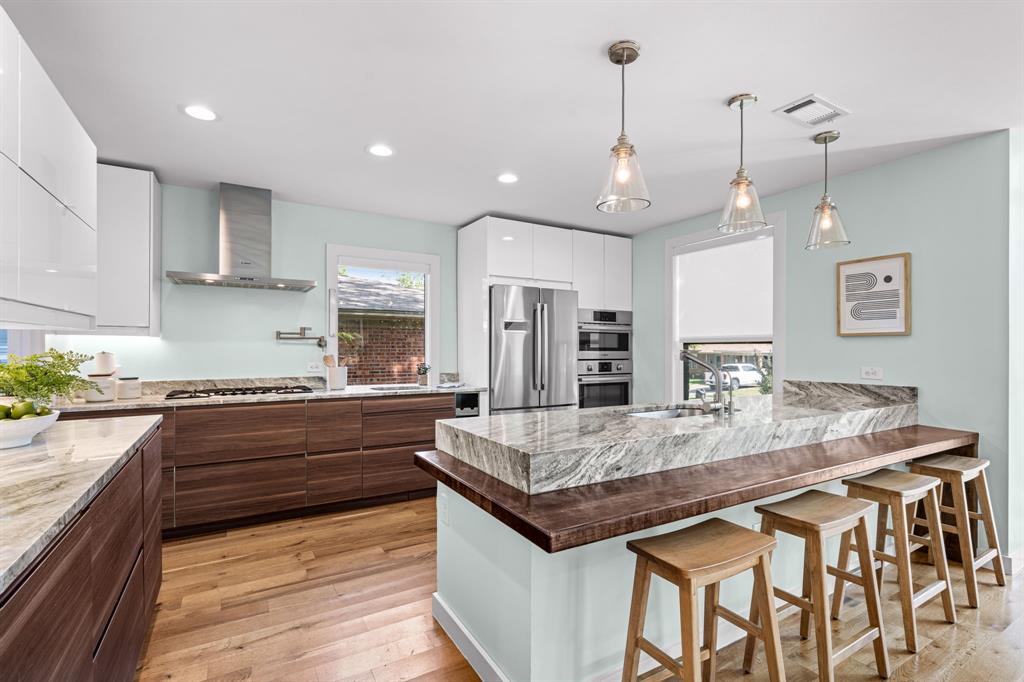 2547 Wentworth Street Dallas, TX 75211 - Photo 5 of 22 a kitchen with granite countertop kitchen island a sink stove and refrigerator