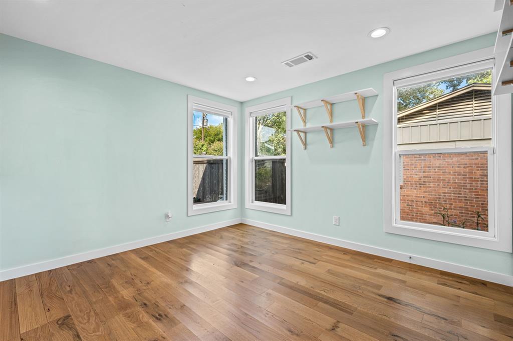 2547 Wentworth Street Dallas, TX 75211 - Photo 7 of 22 an empty room with wooden floor and windows