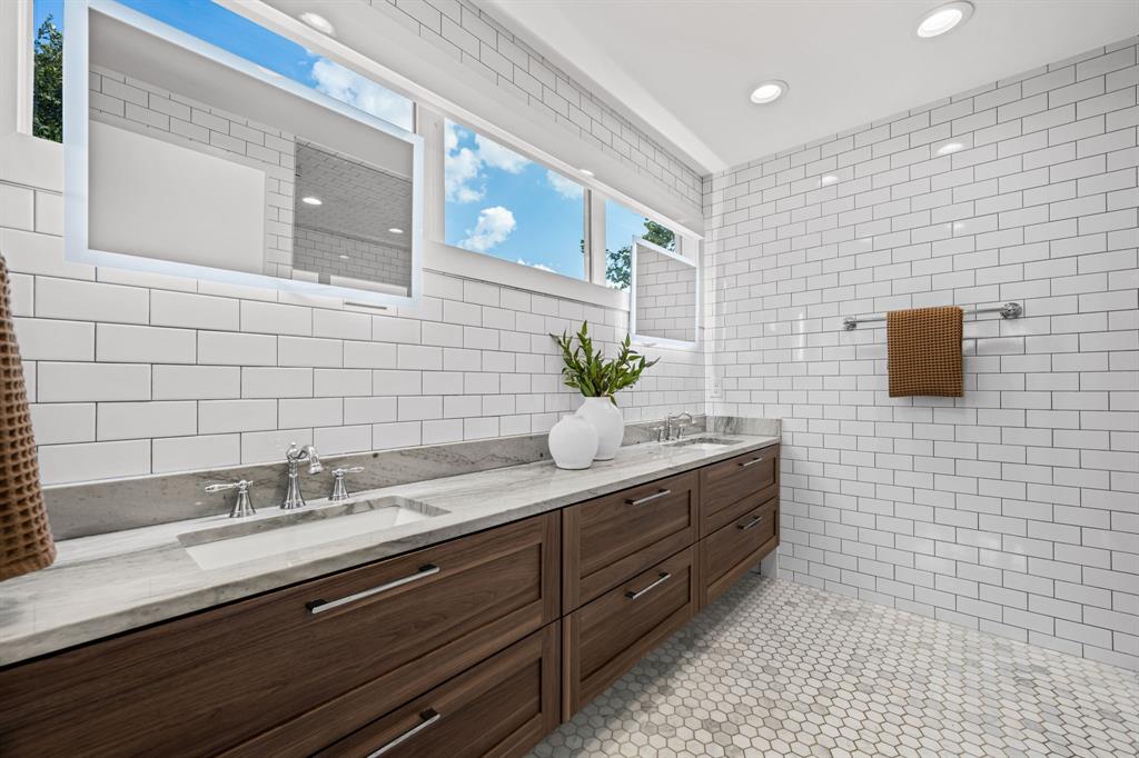 2547 Wentworth Street Dallas, TX 75211 - Photo 10 of 22 a bathroom with a sink a double vanity and a mirror