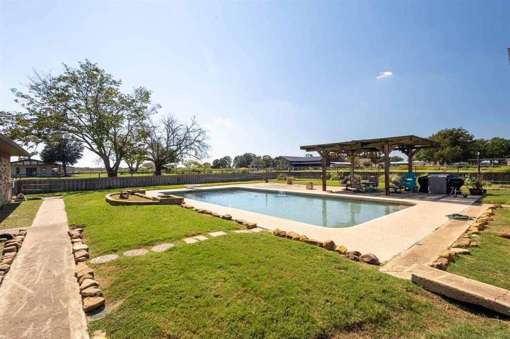 10492 Strittmatter Road Pilot Point, TX 76258 - Photo 7 of 9 a view of a swimming pool with outdoor seating