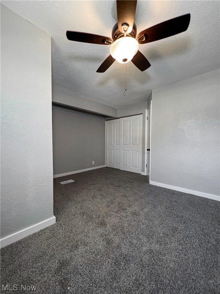 602 West Marshall Road McDonald, OH 44437 - Photo 16 of 19 Carpeted bedroom room featuring ceiling fan and a textured ceiling