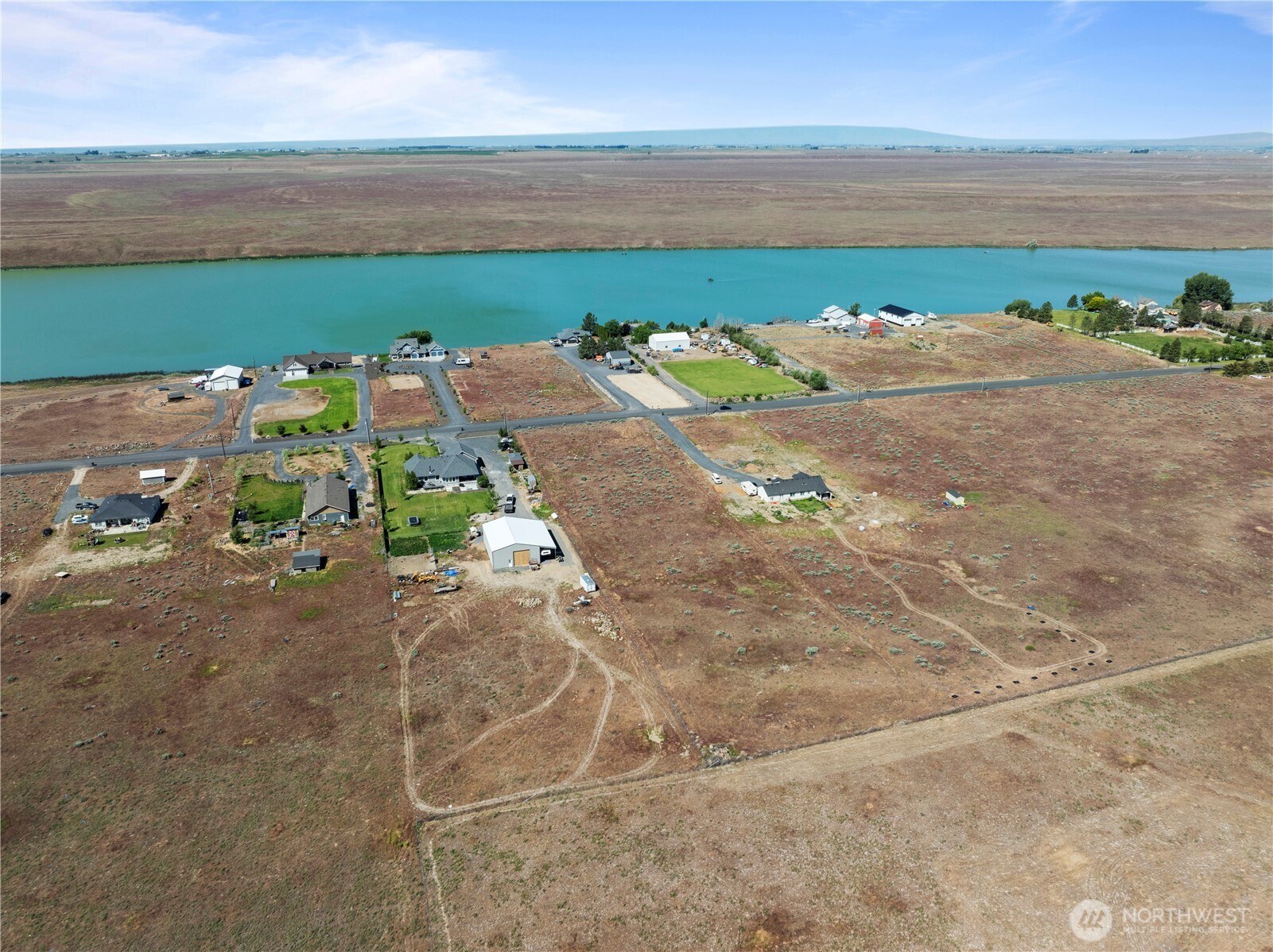 7416 Stonecrest Road Northeast Moses Lake, WA 98837 - Photo 7 of 12 a view of a lake with a yard