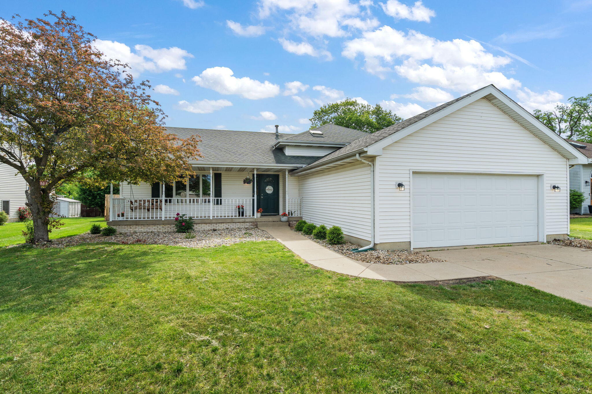 8987 Calhoun Place Crown Point, IN 46307 - Photo 2 of 28 a view of a white house with a big yard and large tree