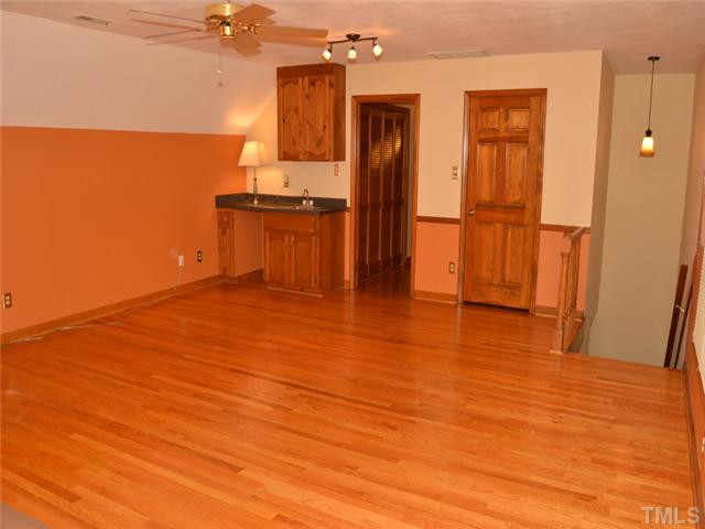 5304 Deep Valley Run Raleigh, NC 27606 - Photo 18 of 25 Huge bonus room can be reached by the back staircase or the upstairs hallway. It has gleaming hardwood floors and a wet bar. Bonus Room
