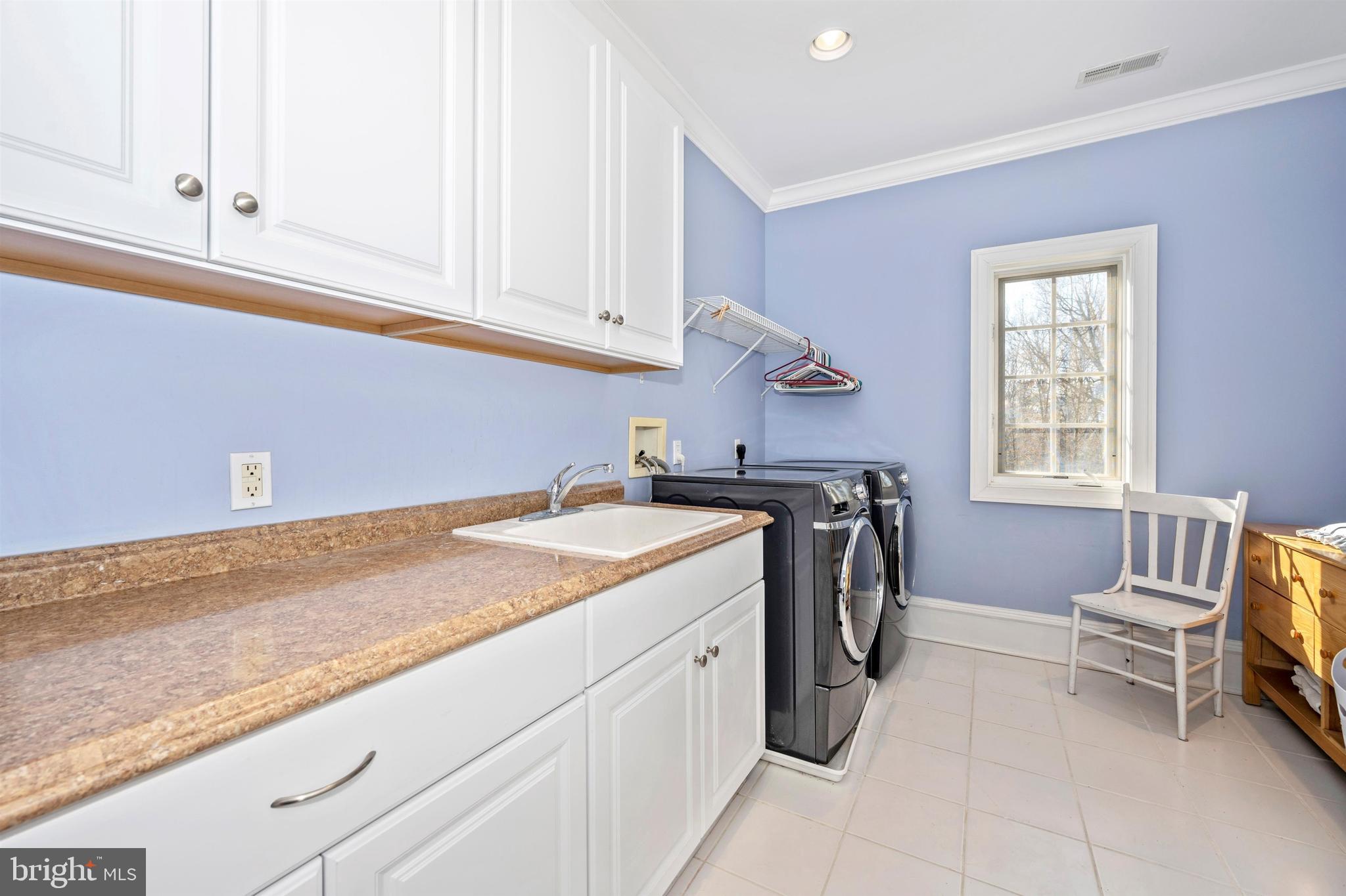 11340 Albermyrtle Road Potomac, MD 20854 - Photo 31 of 42 Laundry room up with front loading washer and drye