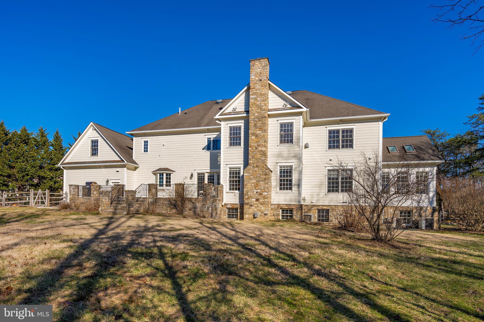 11340 Albermyrtle Road Potomac, MD 20854 - Photo 41 of 42 rear exterior with limestone patio and fenced yard
