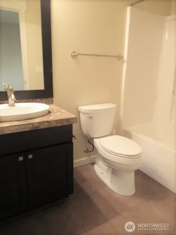 a view of a house that has a flower garden