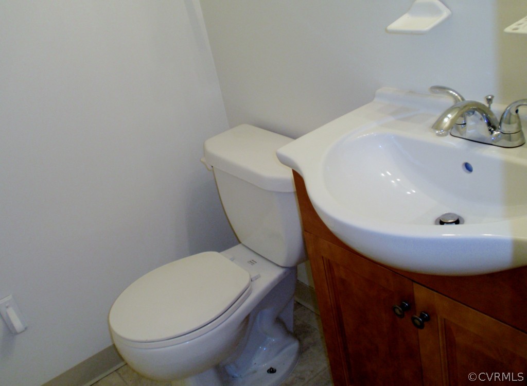 6028 Barrister Road Chesterfield, VA 23832 - Photo 6 of 8 a white toilet sitting next to a bathroom sink