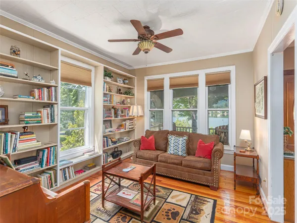 a living room with furniture and a book shelf