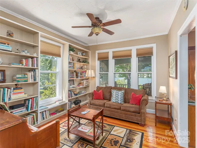 a living room with furniture and a book shelf
