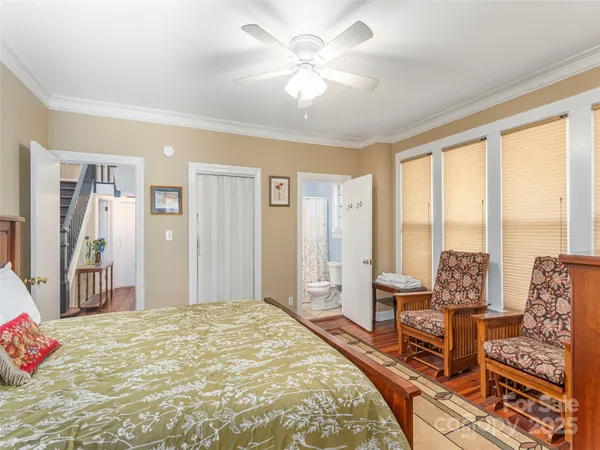 a spacious bedroom with a large bed and large windows