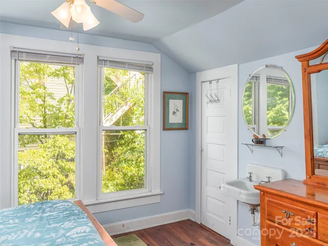 a view of a kitchen with wooden floor and a window