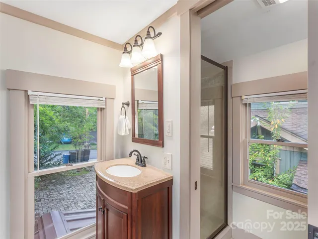 a bathroom with a sink window and a mirror
