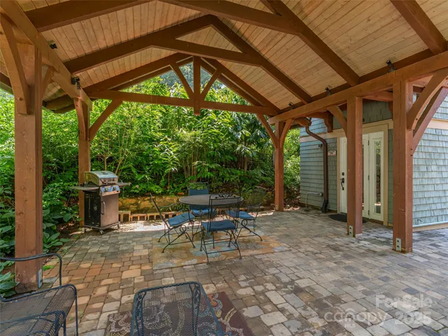 a backyard of a house with table and chairs