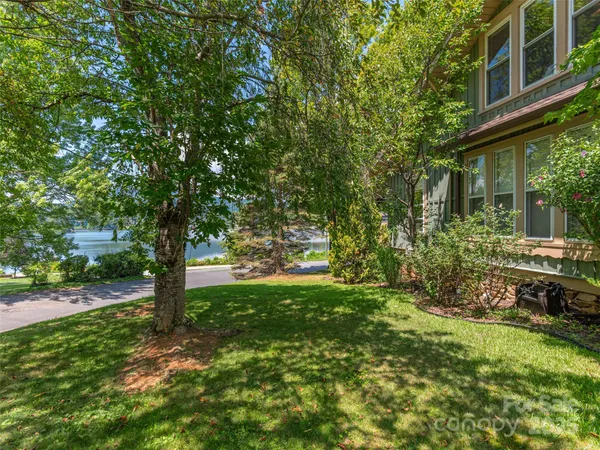 a view of backyard of house with green space