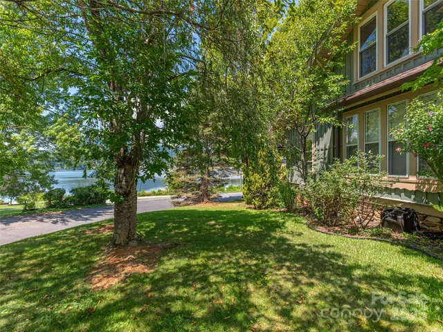 a view of backyard of house with green space