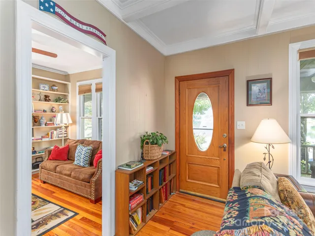 a living room with furniture a bed and a window