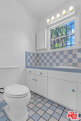 a bathroom with a toilet a sink and a shower