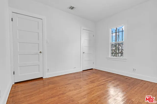 a utility room with wooden floor washer and dryer