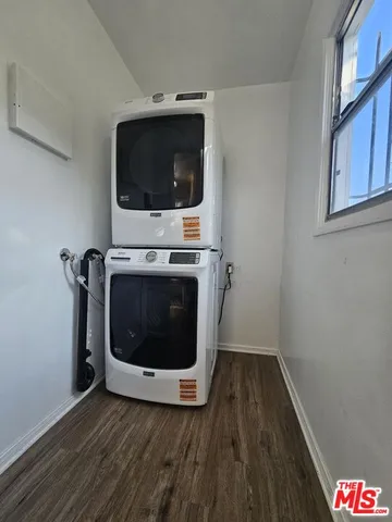 a kitchen with granite countertop a refrigerator and a sink
