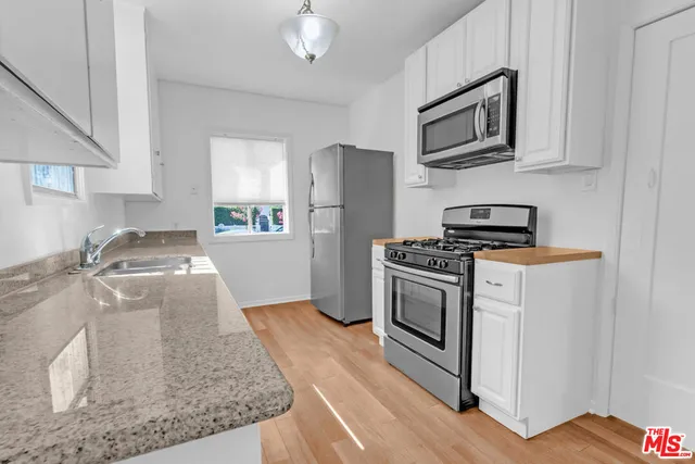a kitchen with a sink stove and window