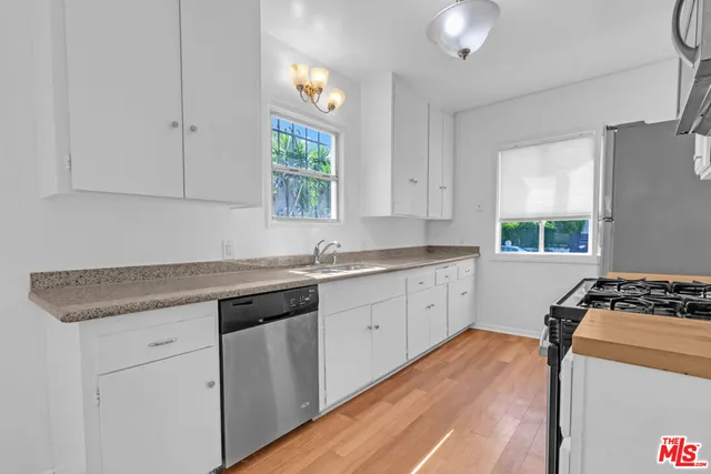 a view of a patio with couches and table with potted plants