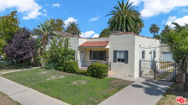 a view of house with yard and swimming pool