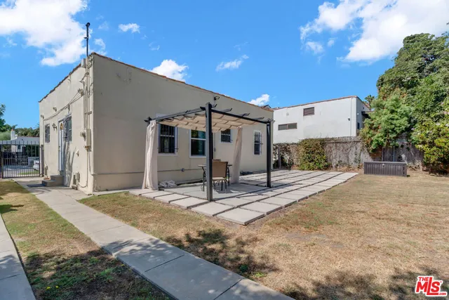 a view of a patio with table and chairs and potted plants