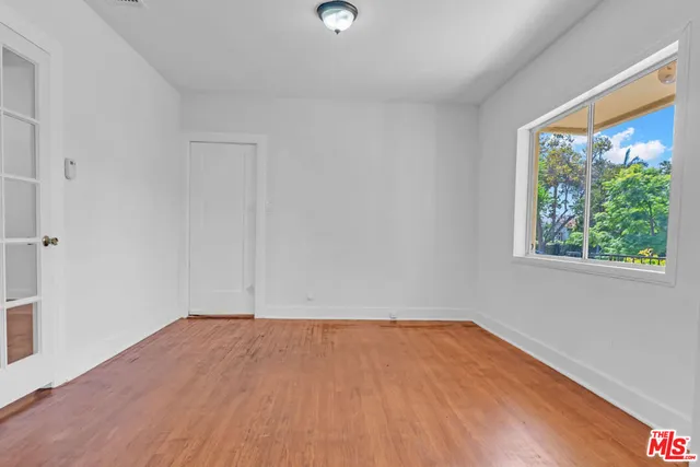 a view of room with window and hardwood floor