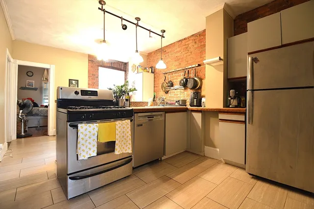 a kitchen with a sink appliances and cabinets