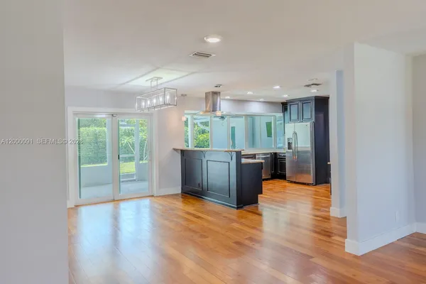 a kitchen with stainless steel appliances granite countertop a refrigerator and a stove