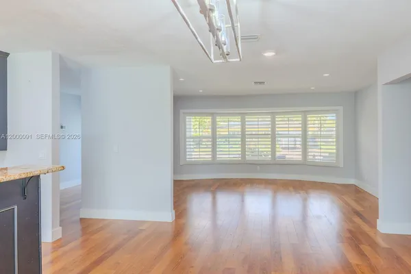 a kitchen with granite countertop a stove and a sink
