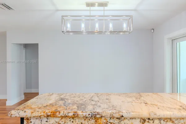 an empty room with wooden floor closet and ceiling fan