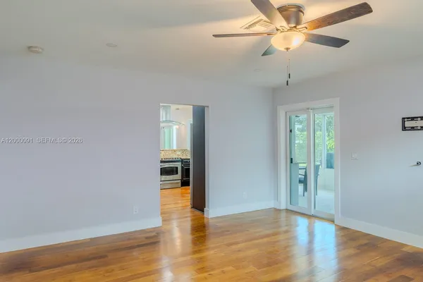 an empty room with wooden floor and closet