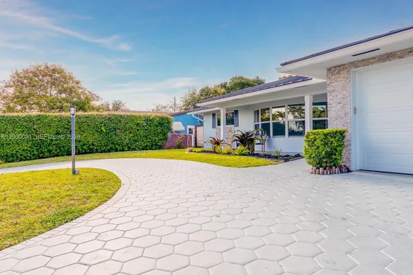 a view of a backyard with table and chairs under an umbrella