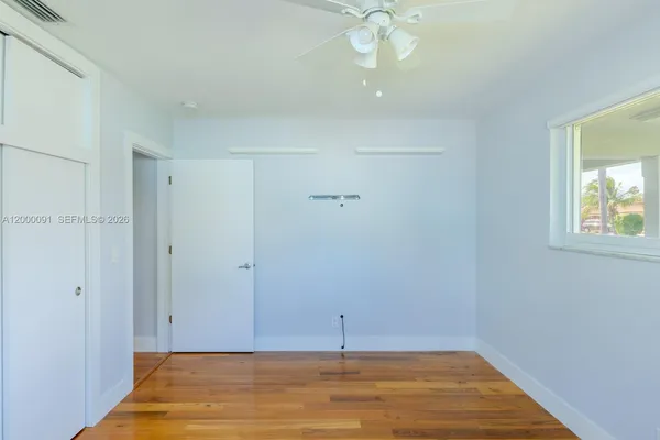 a bathroom with a granite countertop sink a mirror and a shower