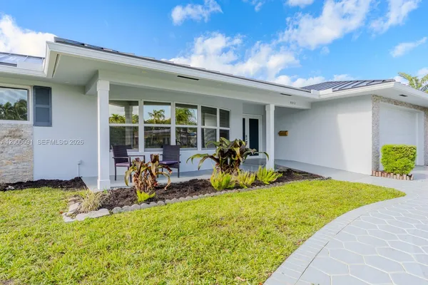 a view of a hallway with wooden floor and a window