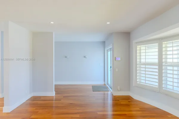 a view of a kitchen and wooden floor